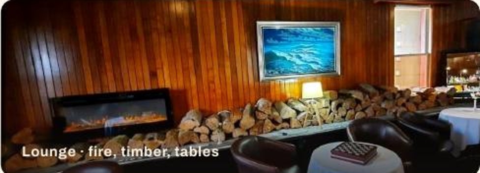 Lounge with fire, timber lining and low tables